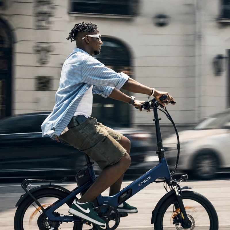 Engwe O20 Boost folding electric bike in Dusty Blue, ridden along a city street