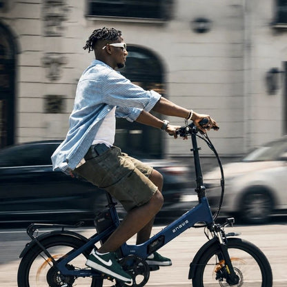 Engwe O20 Boost folding electric bike in Dusty Blue, ridden along a city street